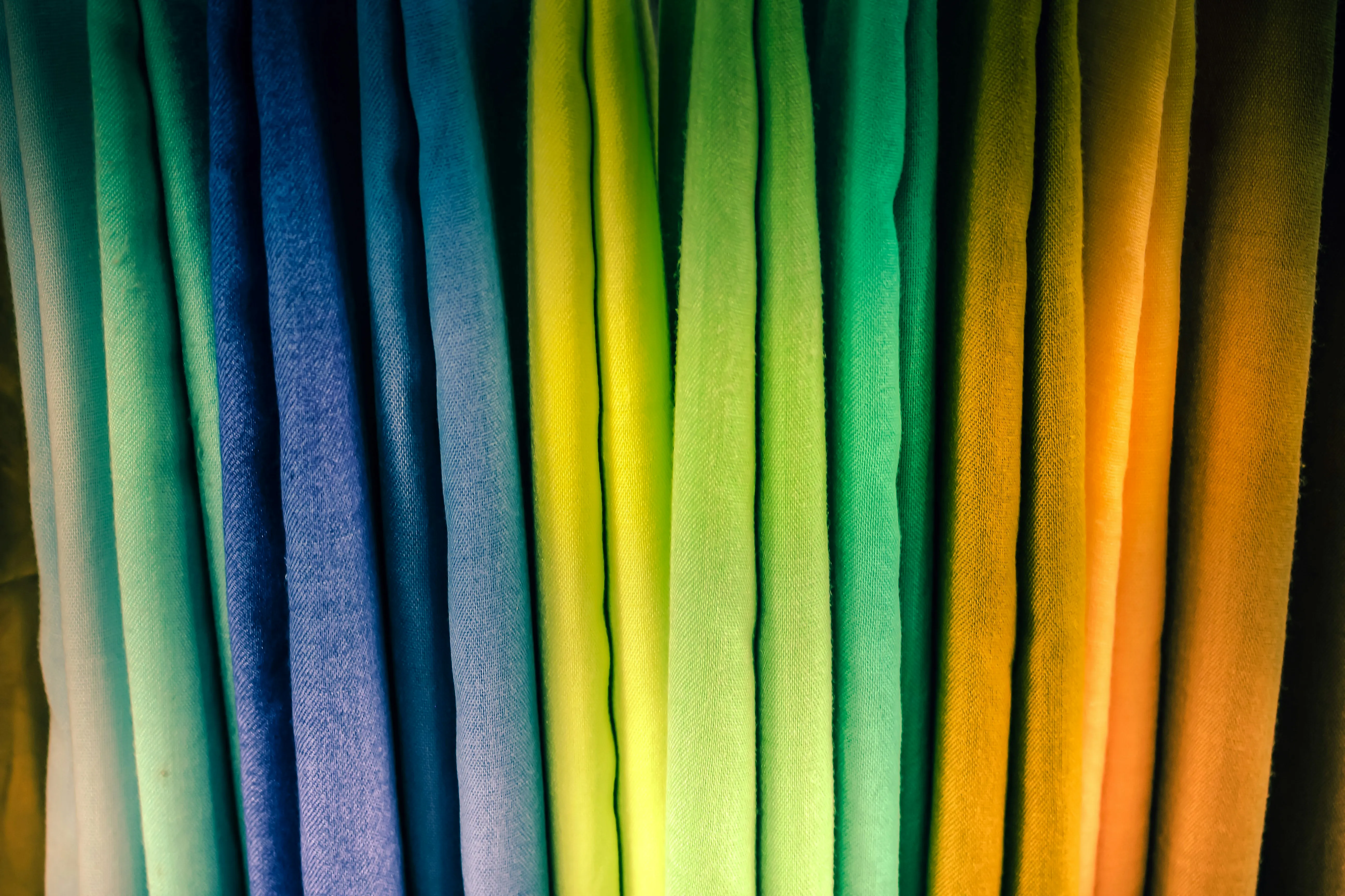 Bolts of cotton fabric displayed inside a textile boutique.